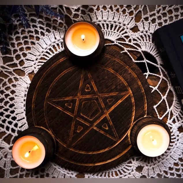 A circle of candles and athames arranged on a wooden table, representing a Wiccan coven gathering.