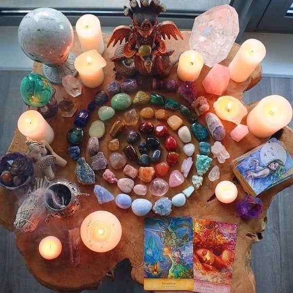 A display of polished quartz, amethyst, and rose quartz crystals on wooden shelves.