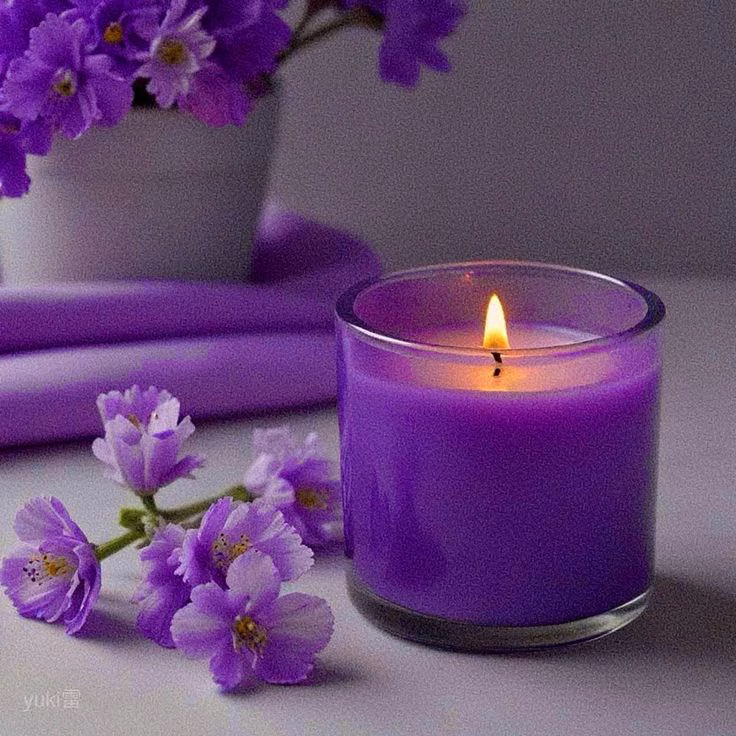 A lit lavender candle beside a glass of water and amethyst crystals on a bedside table for sleep restoration spells.
