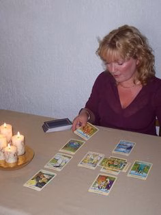 "Witch using tarot cards from American witchcraft supplies."